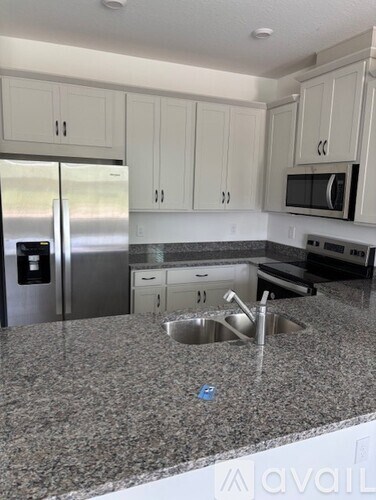 A kitchen with granite countertops and stainless steel appliances.