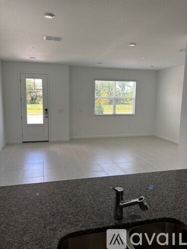 A room with a granite countertop and a sink.