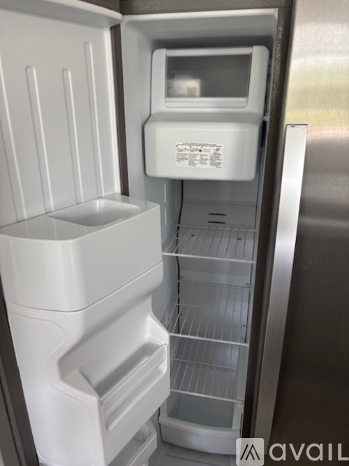 A stainless steel refrigerator with the door open and a water and ice dispenser on the top.