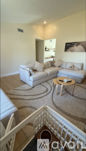 A living room with a white couch and a coffee table.