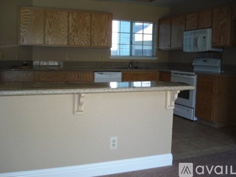 A kitchen with wooden cabinets and a countertop.