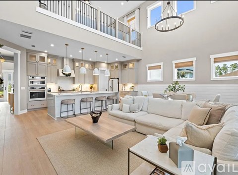 A modern living room with a large white sofa and a coffee table.
