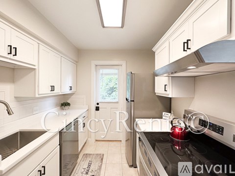 A kitchen with white cabinets and stainless steel appliances.
