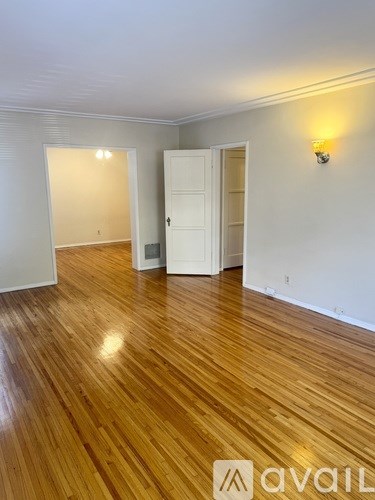 A room with wooden floors and a white door.