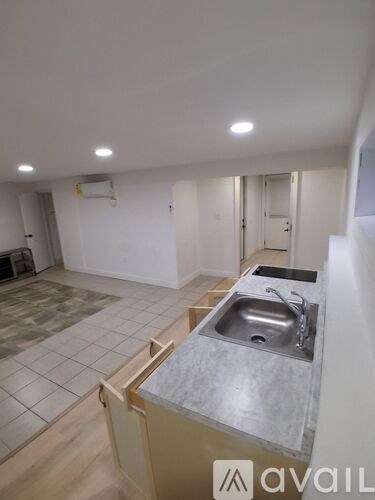 A kitchen with a sink and a counter top.