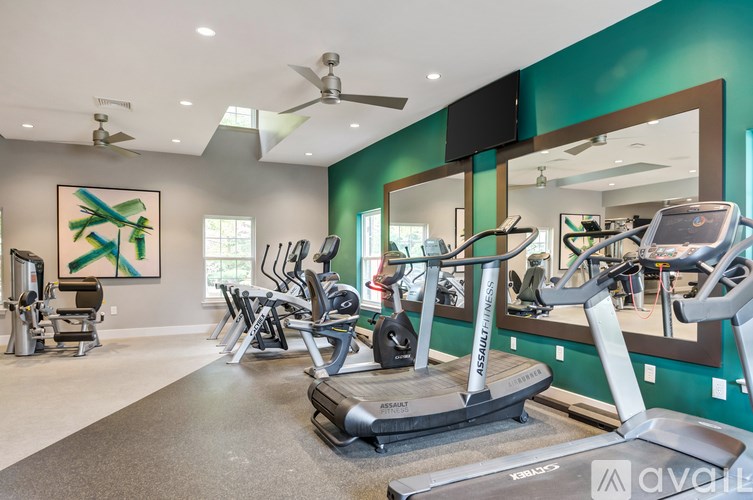 A gym with treadmills and exercise equipment.