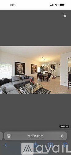 A living room with a grey couch and a coffee table.