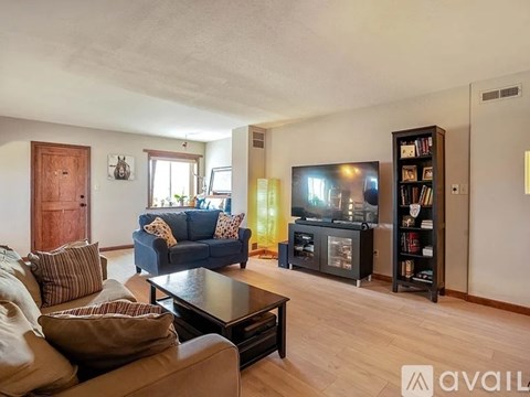 A living room with a blue couch and a television.