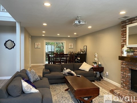 A living room with a grey couch and a coffee table.