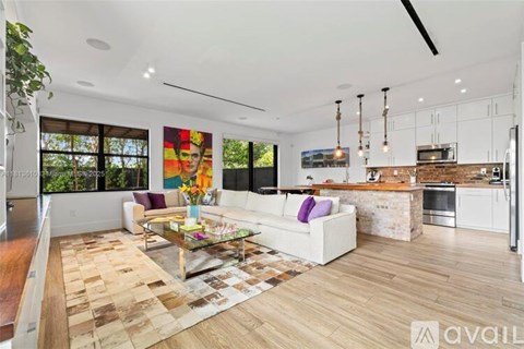 A modern living room with a white sofa and a glass coffee table.