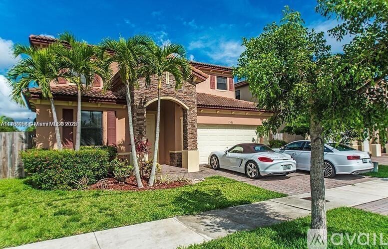 A house with a red roof and a white car parked in front.