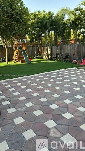 A patio with a checkered pattern of white and red tiles.