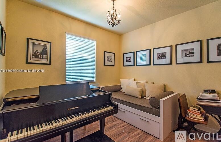 A living room with a piano and a couch.