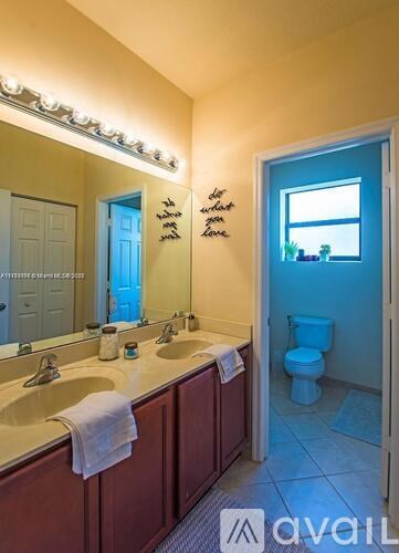 A bathroom with a blue door and a window.