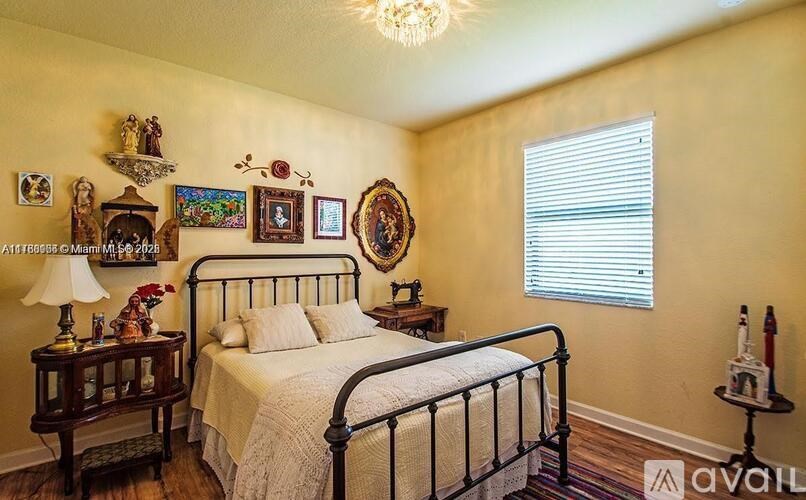 A bedroom with a bed, nightstand, and lamp.