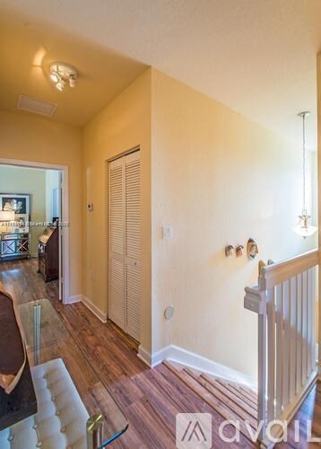 A living room with a staircase leading to the upper floor.