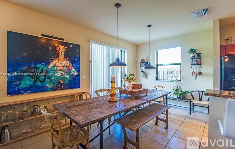 A dining room with a wooden table and chairs.