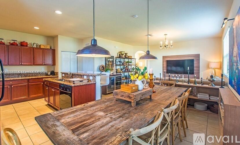 A kitchen with a wooden table and chairs.
