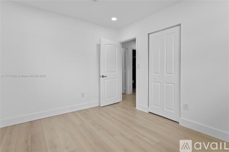 A room with two doors, one of which is open.