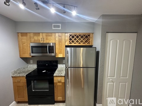 A kitchen with wooden cabinets and stainless steel appliances.