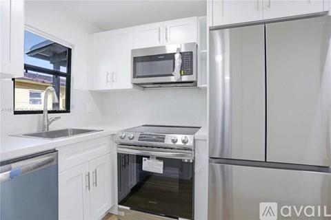 A kitchen with a stove top oven and a microwave above it.