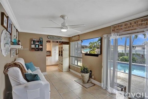 A living room with a white couch and a ceiling fan.