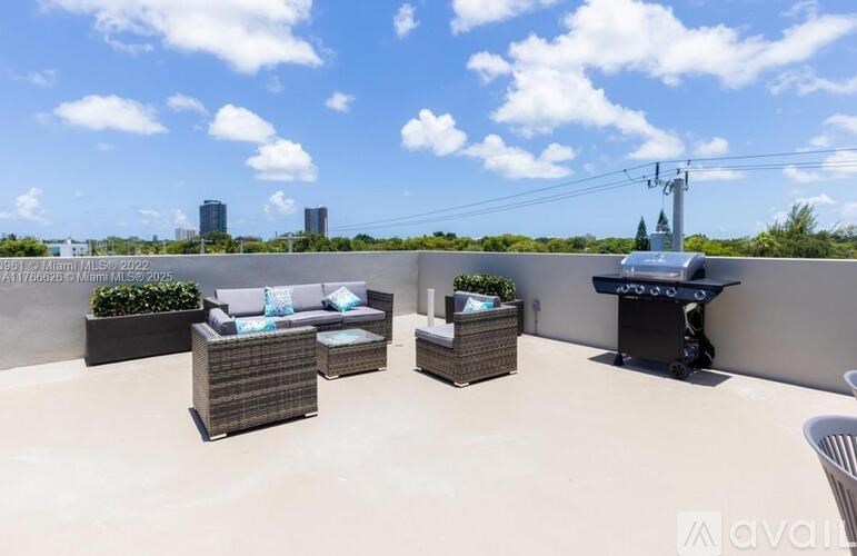 A patio with furniture and a view of the city.