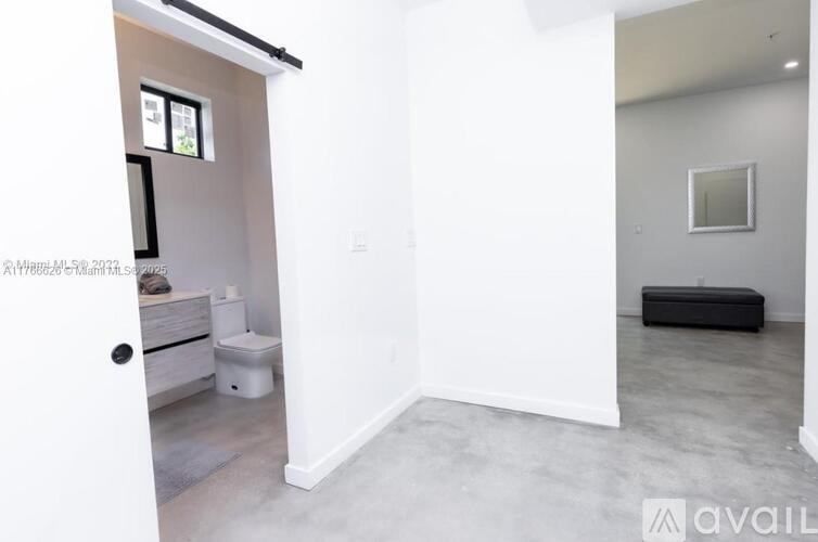A bathroom with a toilet, sink, and mirror.