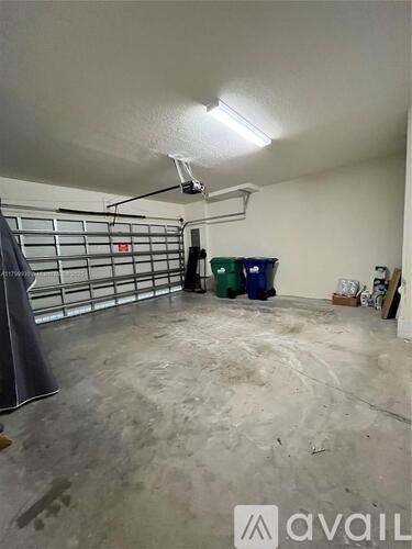 A room with a grey floor and a white ceiling with a light fixture.