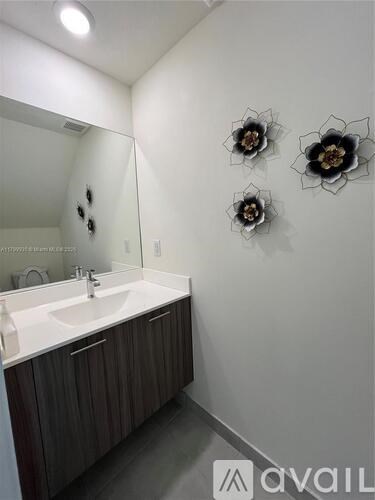 A bathroom with a sink and mirror.