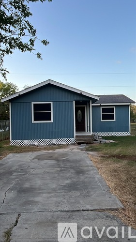 A blue house with a brown door and a window.