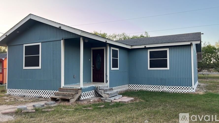 A blue house with a white door and windows.