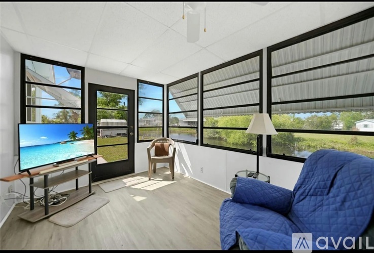 A living room with a television and a chair.