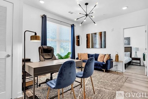 A modern living room with a dining table and chairs.