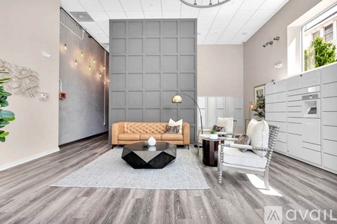 A modern living room with a grey sofa and a grey coffee table.