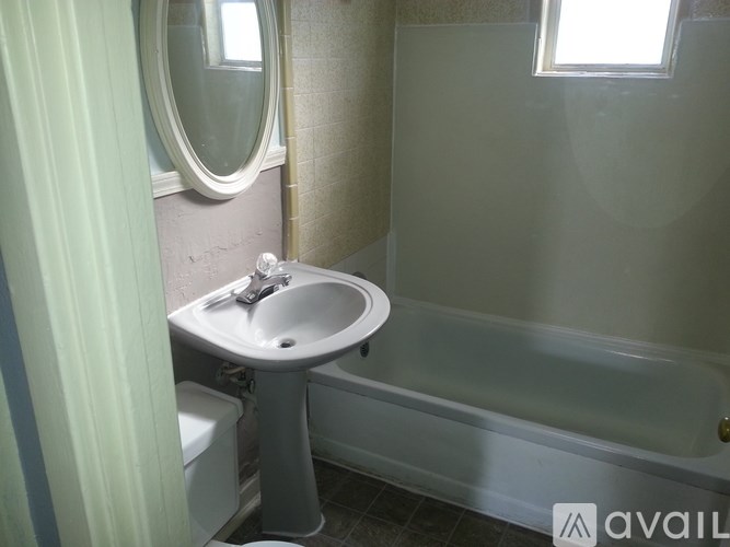 A bathroom with a sink, toilet, and bathtub.