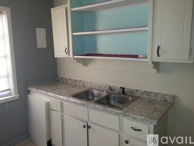 A kitchen with a sink and cabinets.