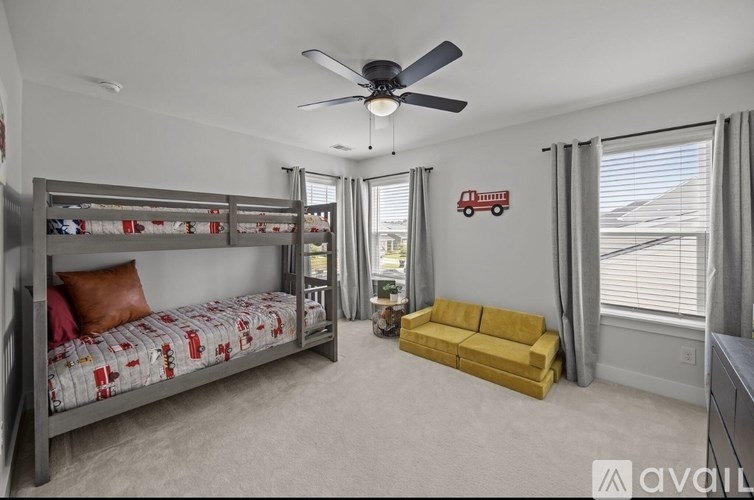 A bedroom with a bunk bed and a yellow sofa.