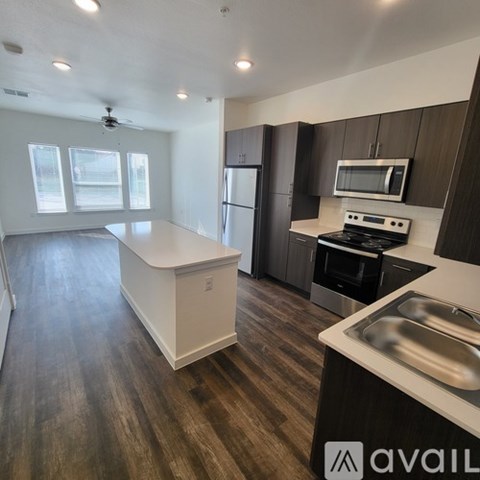 A kitchen with dark wood cabinets and stainless steel appliances.