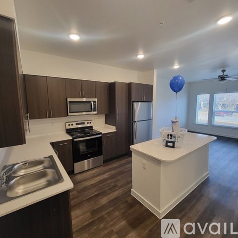 A kitchen with brown cabinets and a white island.