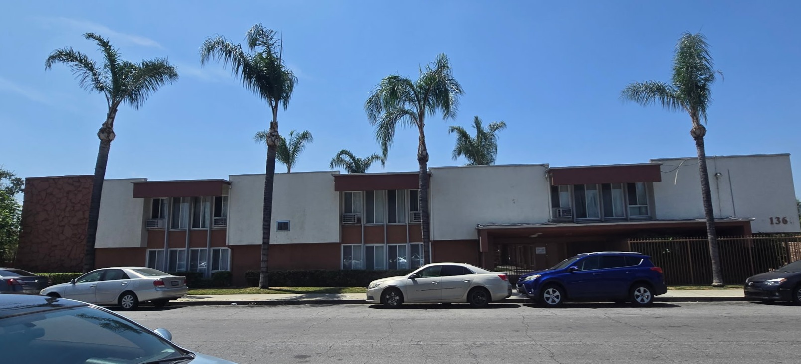 A building with a parking lot in front of it.