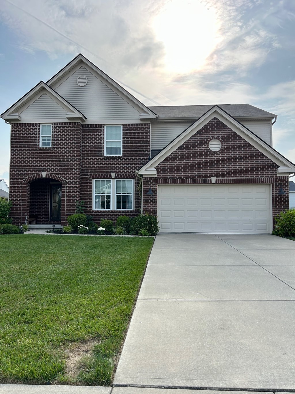 A house with a brick facade and a white garage door.