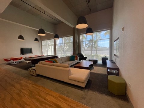 A living room with a white couch and a television.