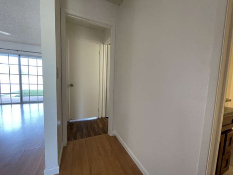 A room with white walls and a wooden floor.