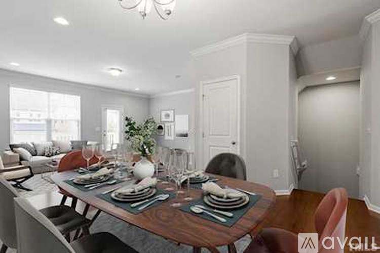 A dining room with a table set for a meal.