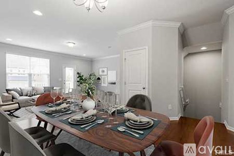 A dining room with a table set for a meal.