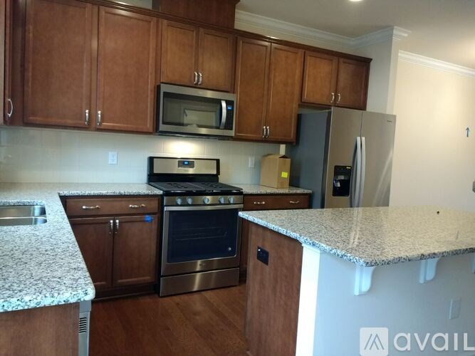 A kitchen with granite countertops and stainless steel appliances.