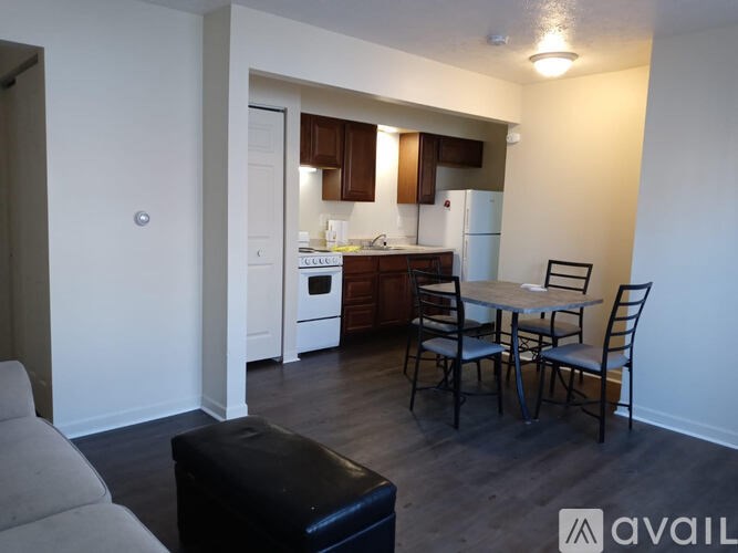 A kitchen with a table and chairs in the middle of the room.