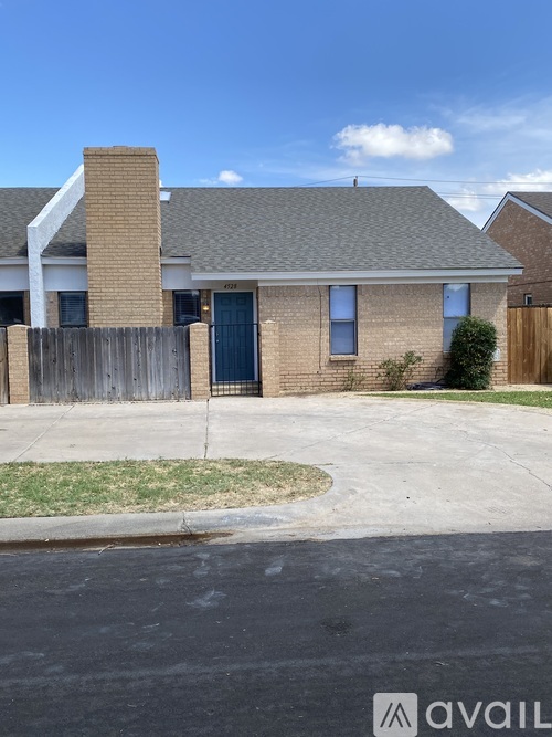 A house with a grey roof and a brown fence.