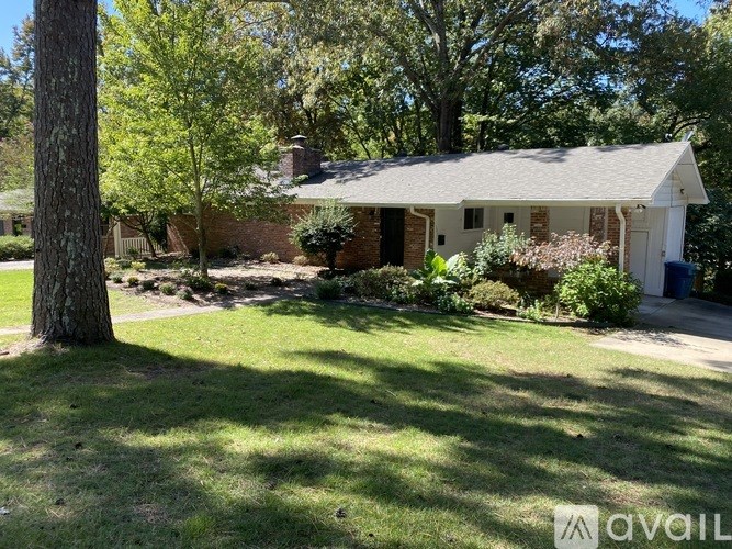 A house with a white front porch and a tree in front.